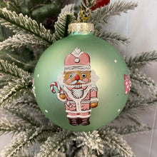 Load image into Gallery viewer, Glass Bauble with Nutcrackers