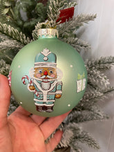 Load image into Gallery viewer, Glass Bauble with Nutcrackers